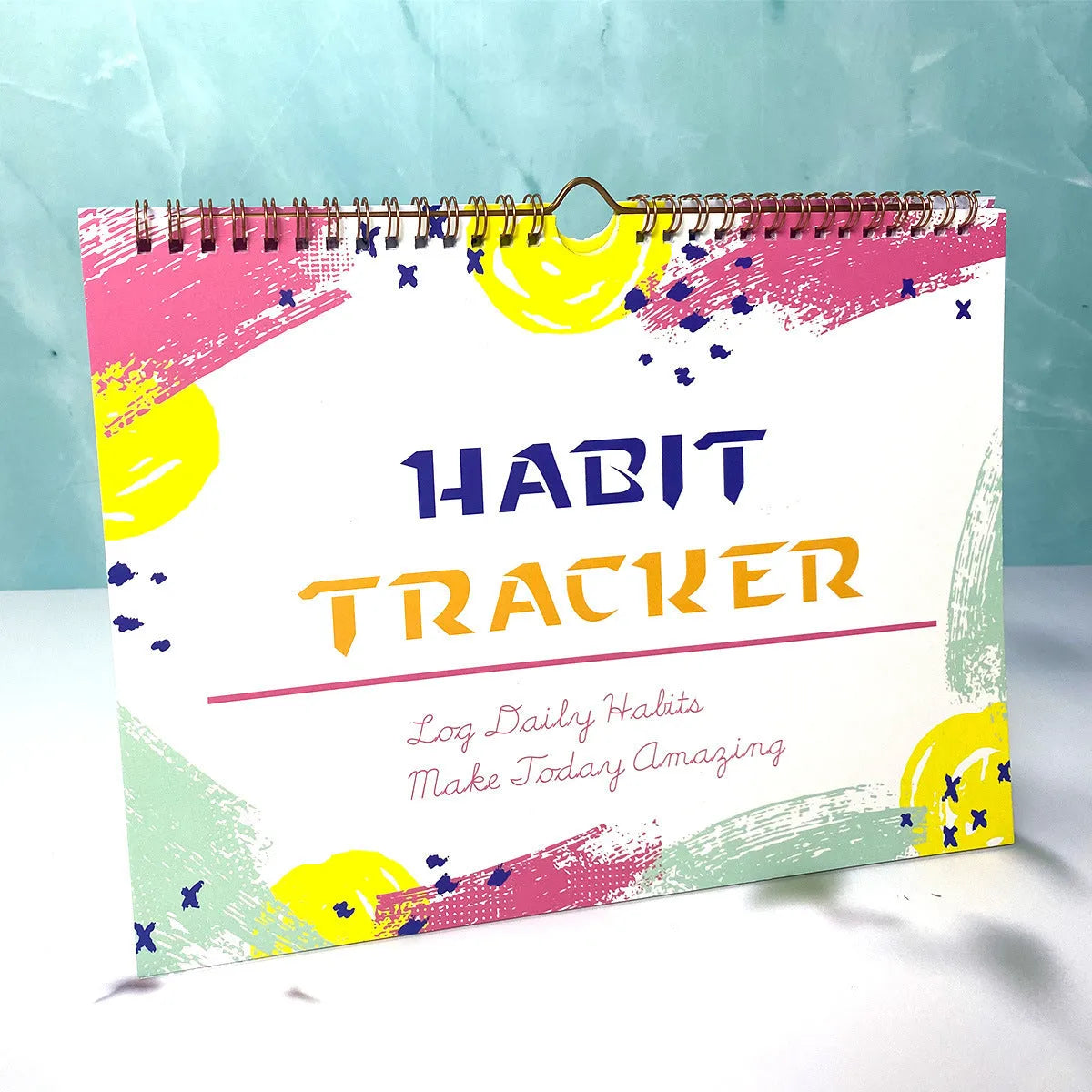 Habit tracking book with 12 pages measuring 21cm by 28cm in four colour options