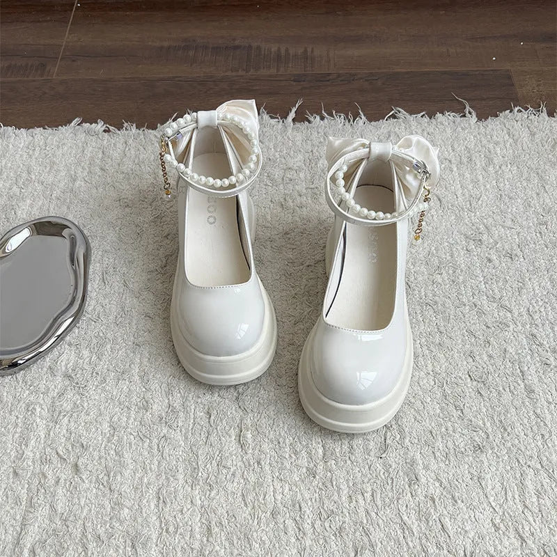 Women's black Mary Jane pumps with chunky heels and round toe on neutral background