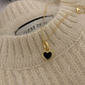 Double-sided shell love pendant necklace with mixed gem inlay on adjustable chain, available in gold-plated copper or titanium steel