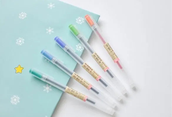 Pack of 12 black Muji gel pens with 0.5mm fine tips on a white background