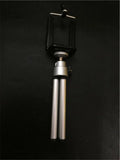 Black and silver metal desktop phone holder with an adjustable two-section bracket on a wooden desk.