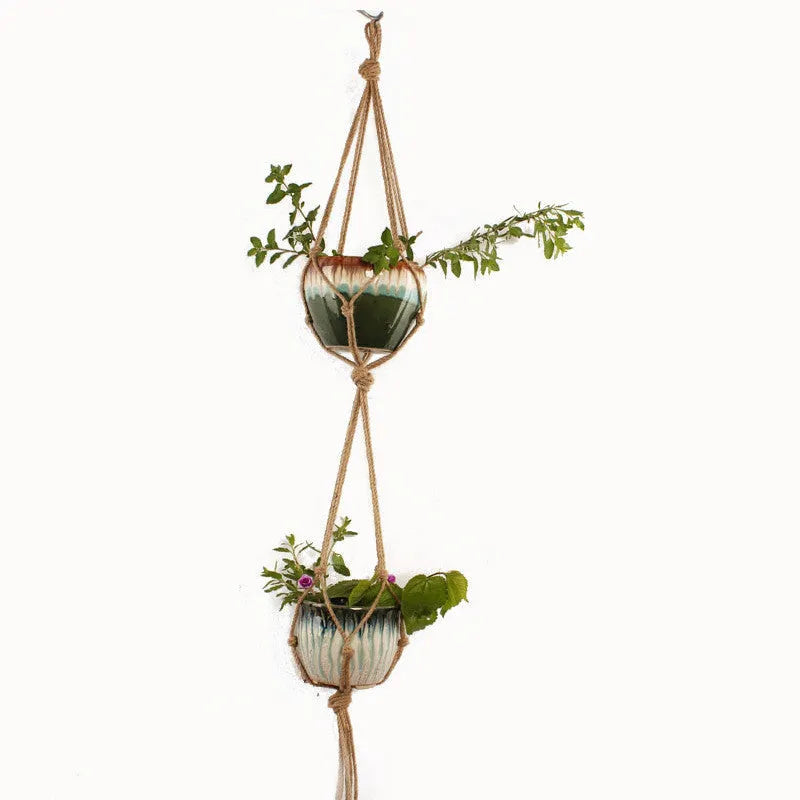Natural cotton rope woven wire plant basket in a rustic style, shown holding a small potted plant.