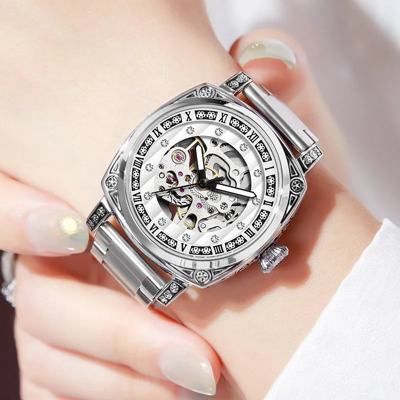 Men's black mechanical watch with luminous hands on a leather belt strap with needle detailing.