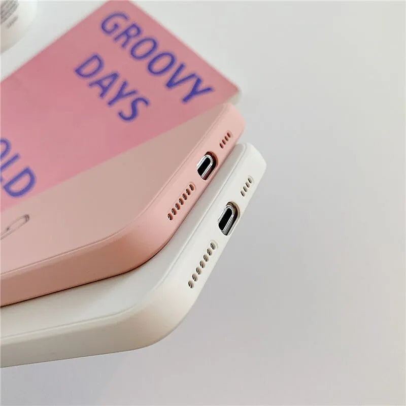 Solid colour silicone TPU back cover case for Apple iPhone on a table, showing colour options.