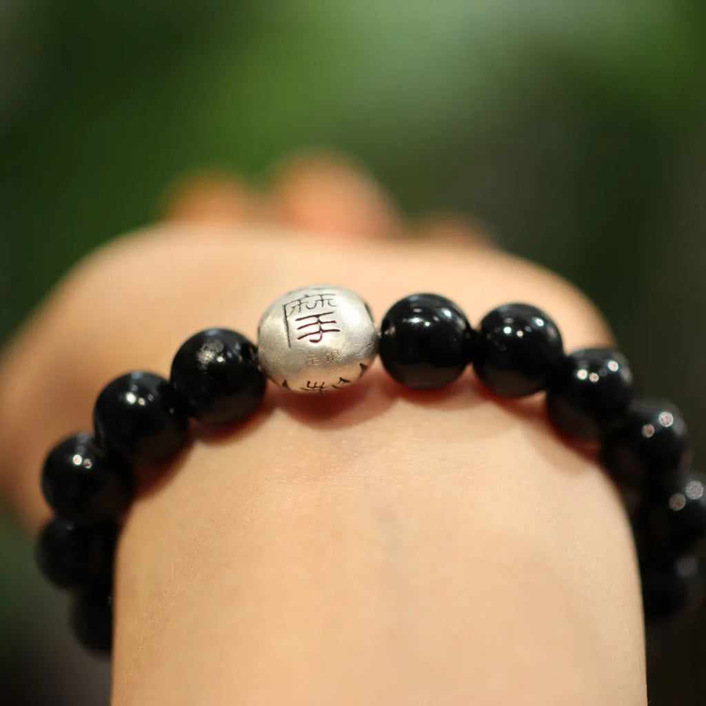 Black agate bracelet with 10mm beads, sterling silver components, and Chinese style design