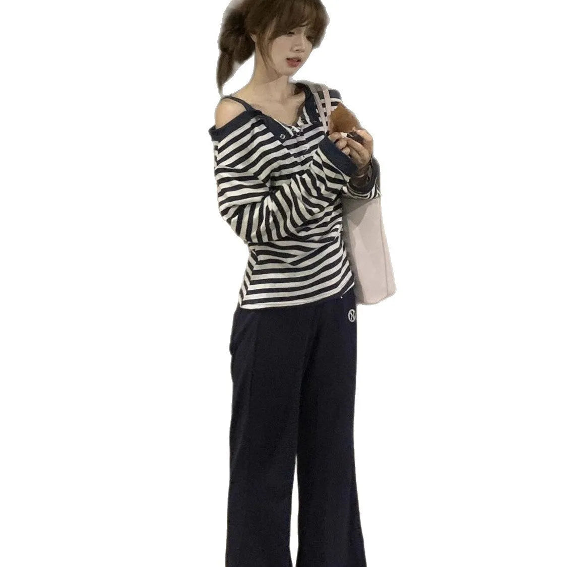 Dark blue women's long-sleeved t-shirt with an oversized fit, showing stripe and embroidery detail on the front.
