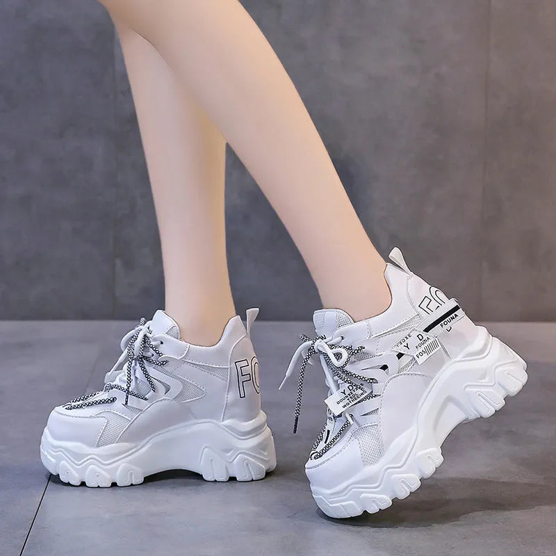 Women's white mesh platform sports shoes with cross strap and round toe on rubber sole.