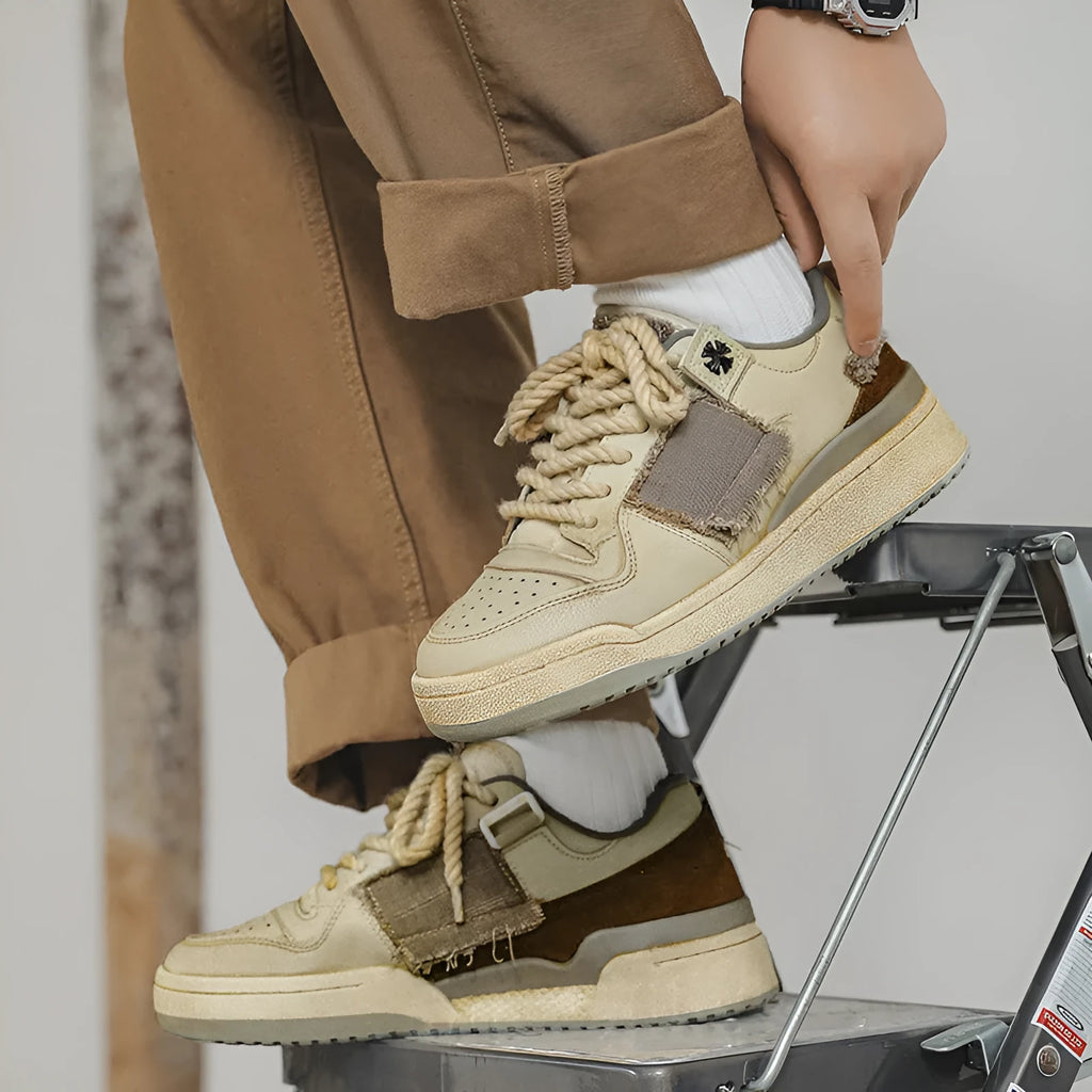 Beige low-top vintage skate shoes with lace-up front and rubber sole.