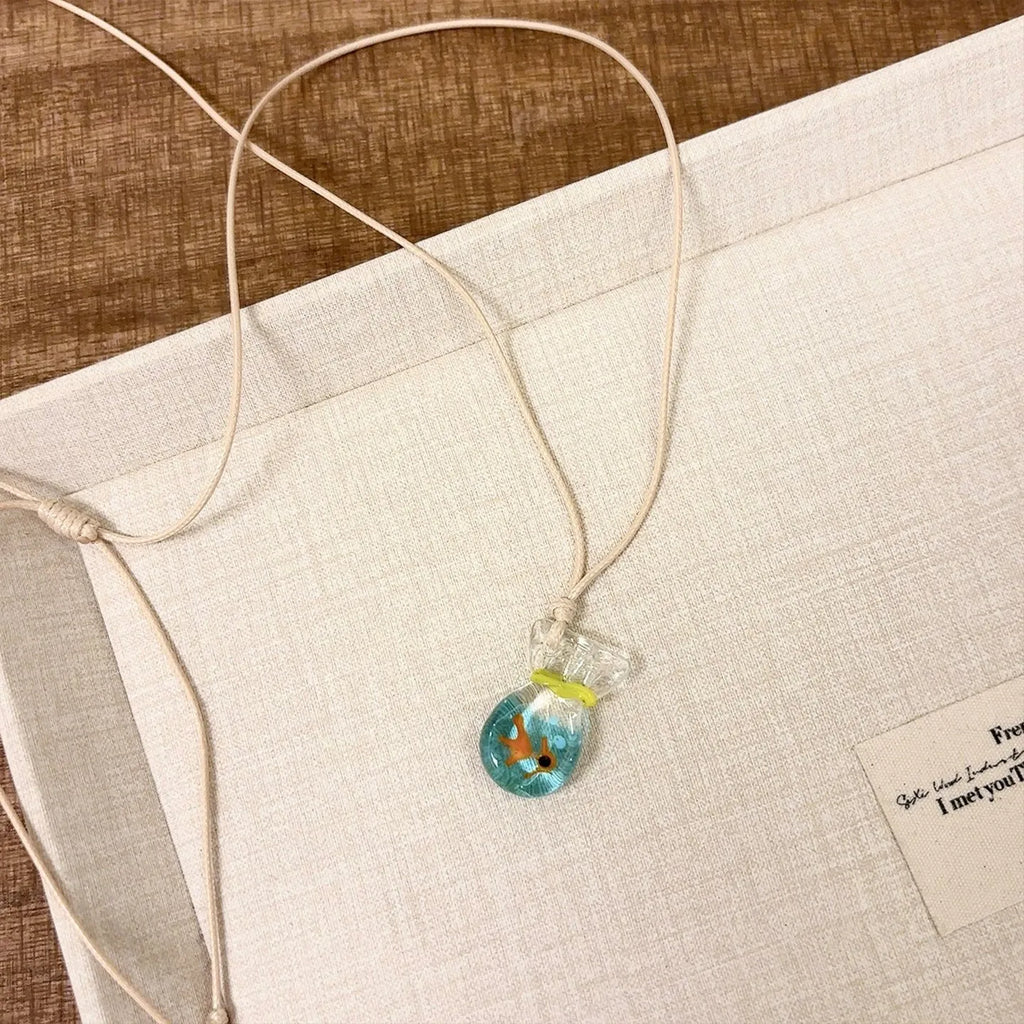Women's skirt and joker charm pendant necklace with coloured glass on a cotton linen clavicle chain.