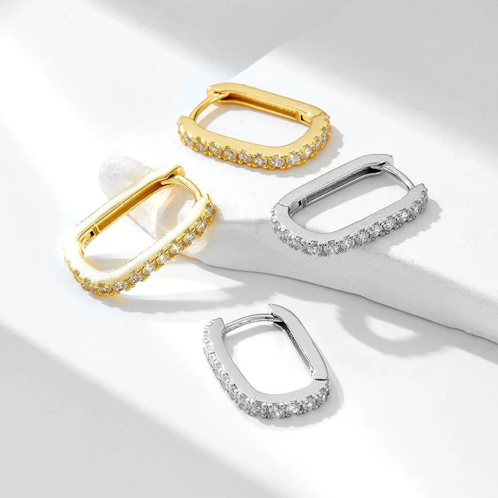 Close-up of a women's sterling silver earring featuring an oval-cut zircon stone.