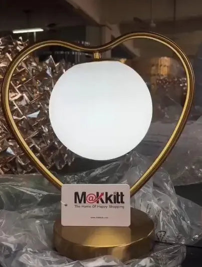 Clear acrylic heart-shaped USB night light with warm white LED on a surface.