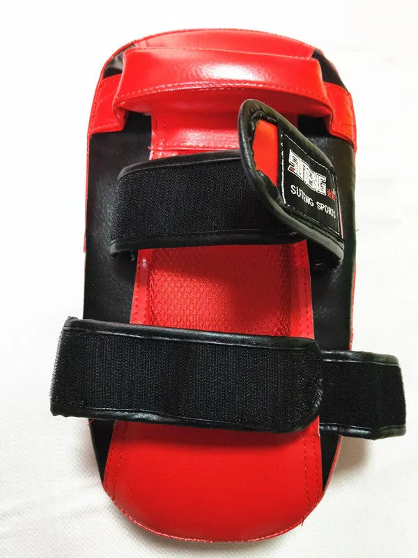 Black square boxing training pad with red trim, showing back with double buckle straps.