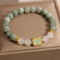 Women's oil green emerald crystal bracelet with five scriptural charms on wrist