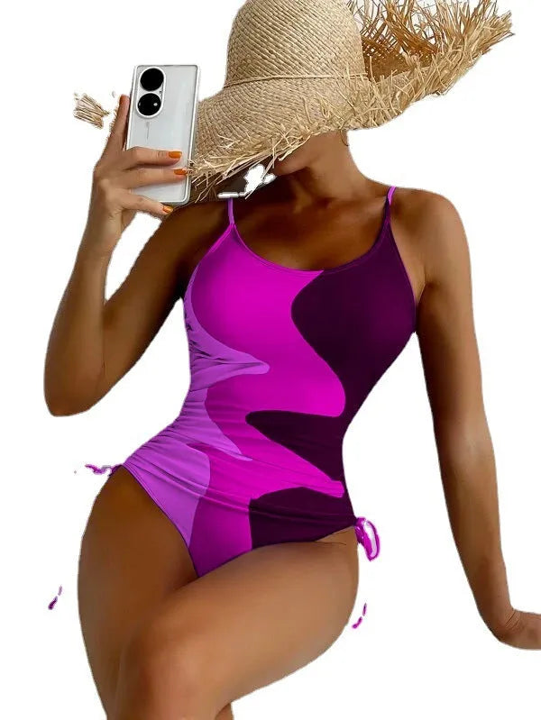 Women's blue sleeveless backless one-piece swimsuit on hanger