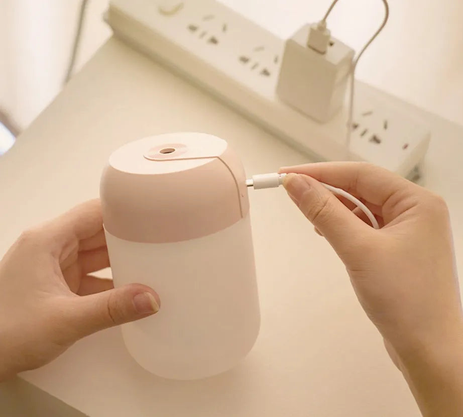 Small white cylindrical USB humidifier with aromatherapy function for desk use