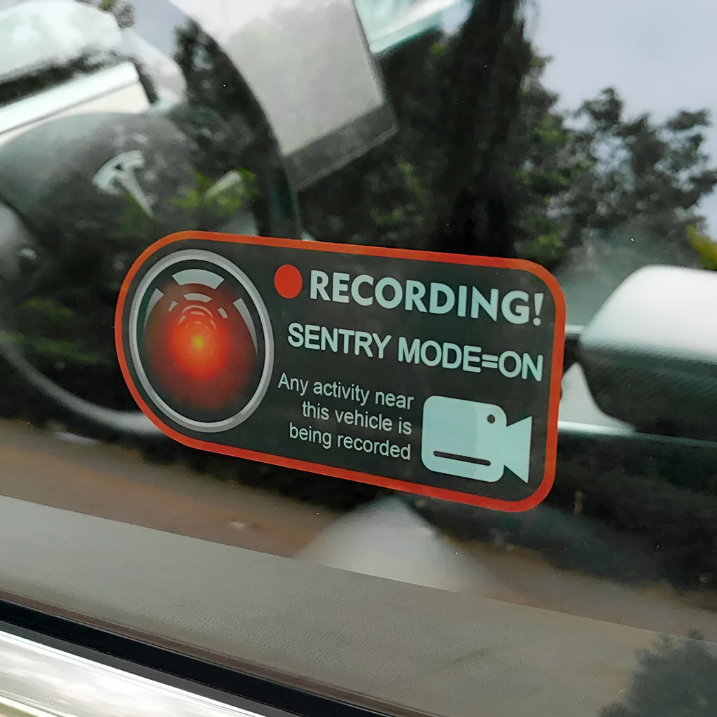Two white electrostatic warning stickers for Tesla Sentry Mode, each measuring 11 by 5 centimetres.
