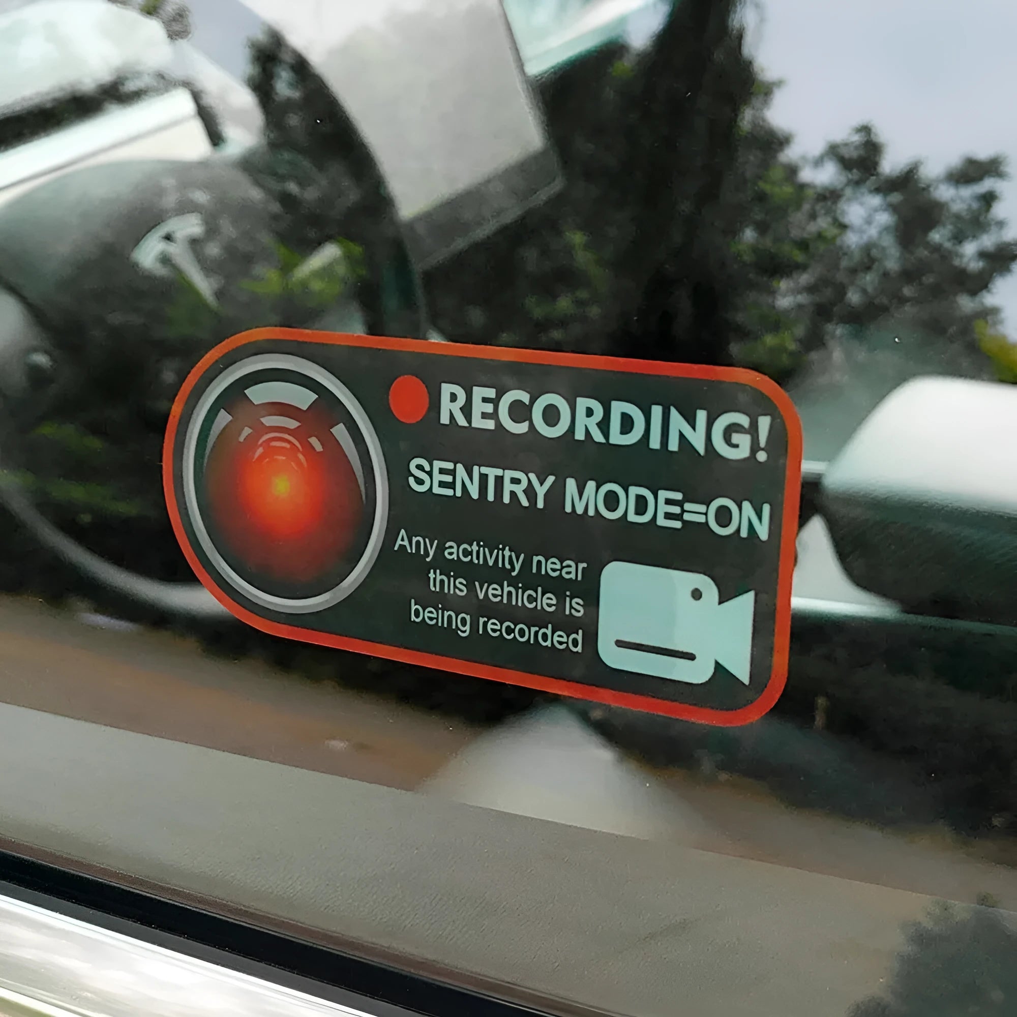 Two white electrostatic warning stickers for Tesla Sentry Mode, each measuring 11 by 5 centimetres.