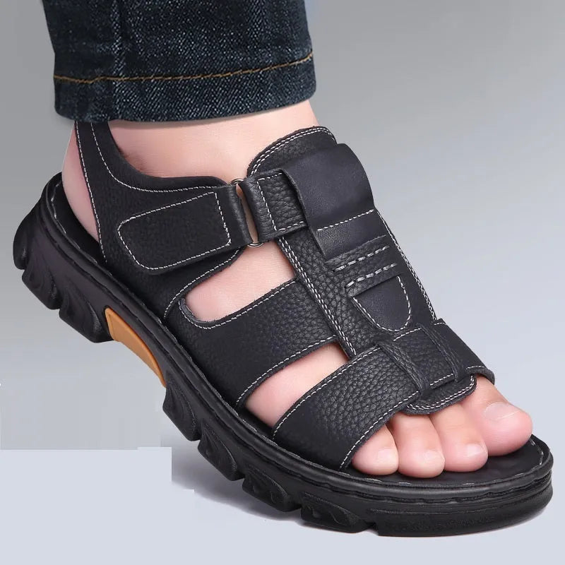 Men's brown cowhide leather sandals with velcro strap and open toe on a beach background