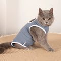 Blue pet sterilization suit with adjustable scarf on a cat, cotton anti-licking clothing for post-surgery recovery.