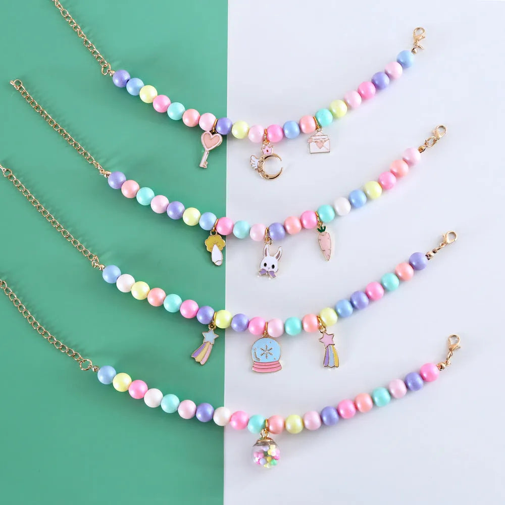 Colourful macaron-themed resin collar and bracelet set for pets on a pastel background.