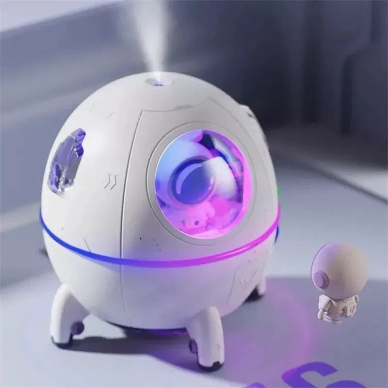 Astronaut-themed desktop humidifier with colourful LED lights showing 110mm cubic dimensions
