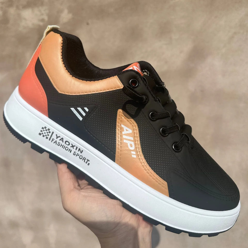 Men's white and orange artificial PU casual shoes with round toe on a solid background.