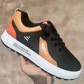 Men's white and orange artificial PU casual shoes with round toe on a solid background.