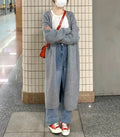 Women's loose-fit mid-length knitted cardigan in grey, showing V-neck and long sleeves.