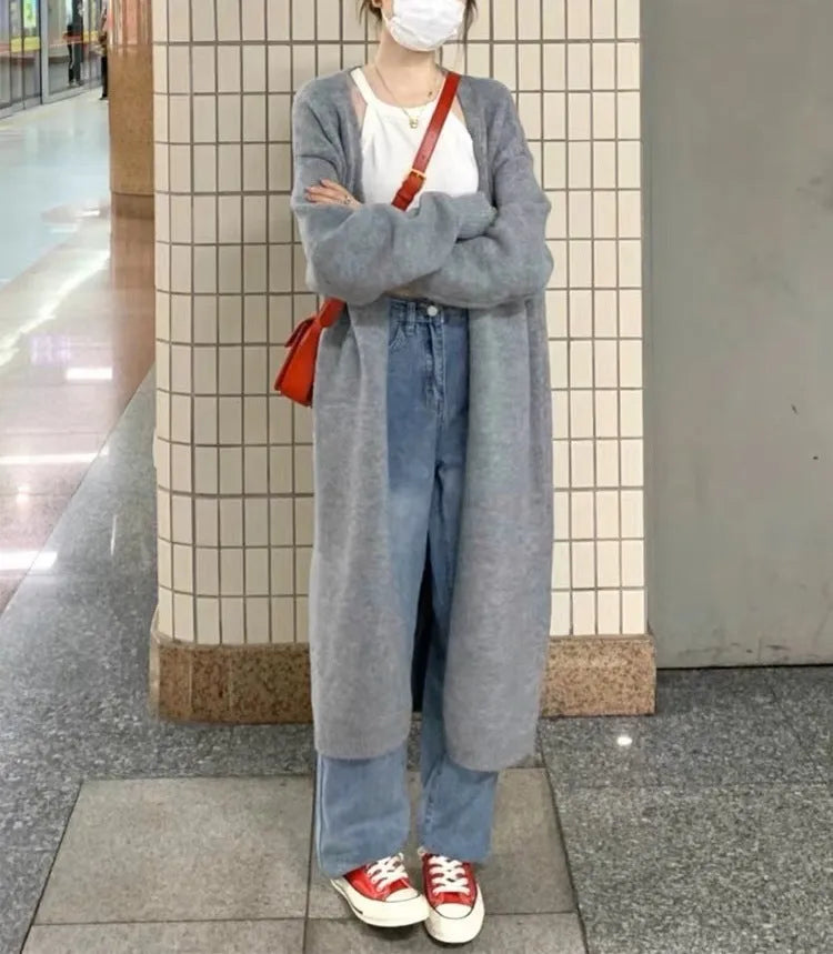 Women's loose-fit mid-length knitted cardigan in grey, showing V-neck and long sleeves.