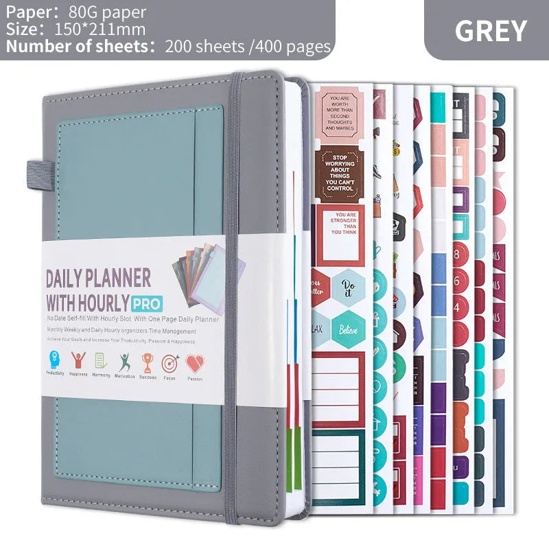 A5 undated notebook with PU leather cover in six colours, open to show flat-lay binding and planning stickers.