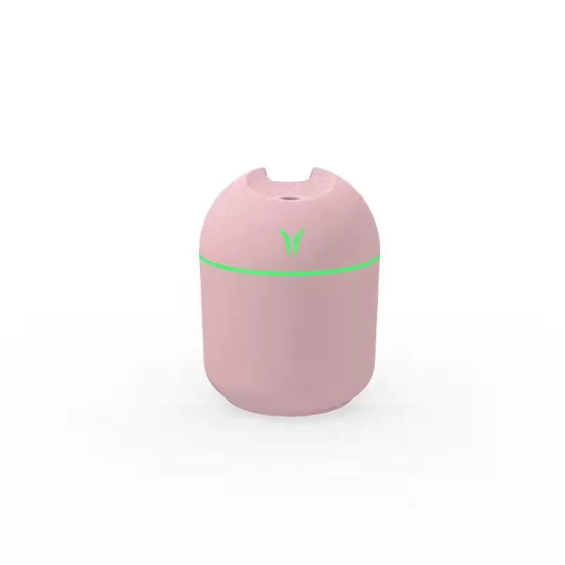 Round desktop humidifier in ivory white colour with USB cable and water tank showing 250ml capacity