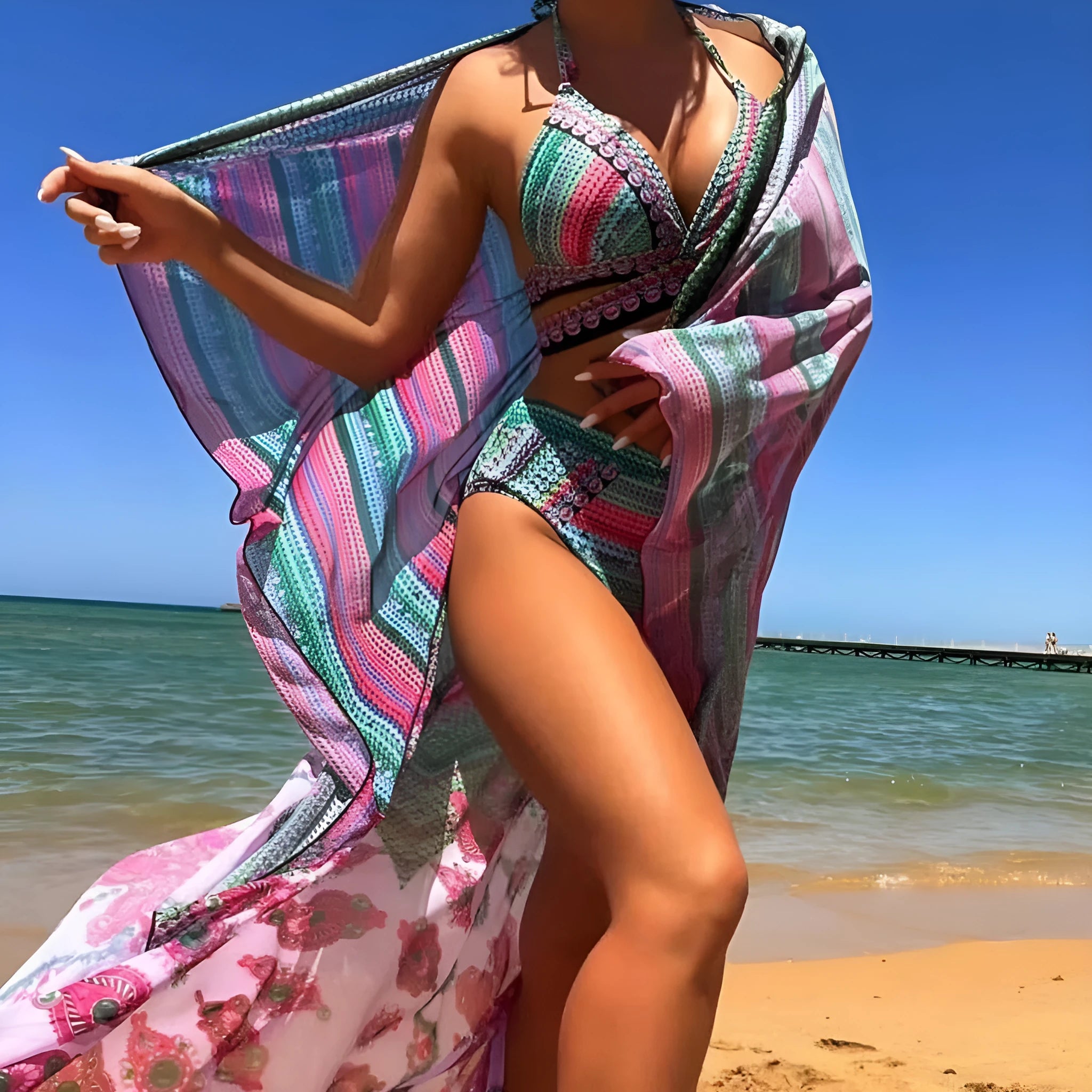 Women's three-piece bikini swimsuit set showing cross bandage top, high-waist bottoms, and split-side veil cover-up