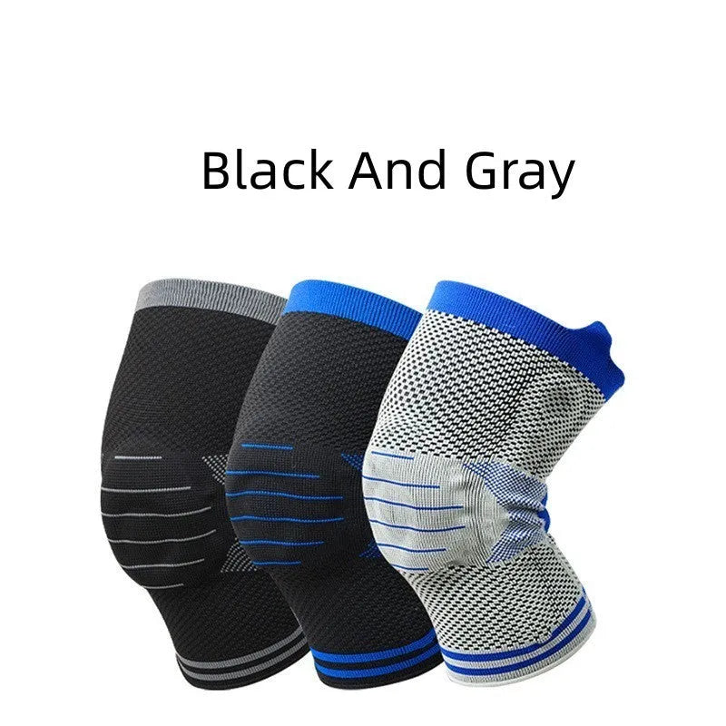 Black and gray knee pad with silicone shock absorber for sports protection on a leg.