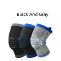 Black and gray knee pad with silicone shock absorber for sports protection on a leg.