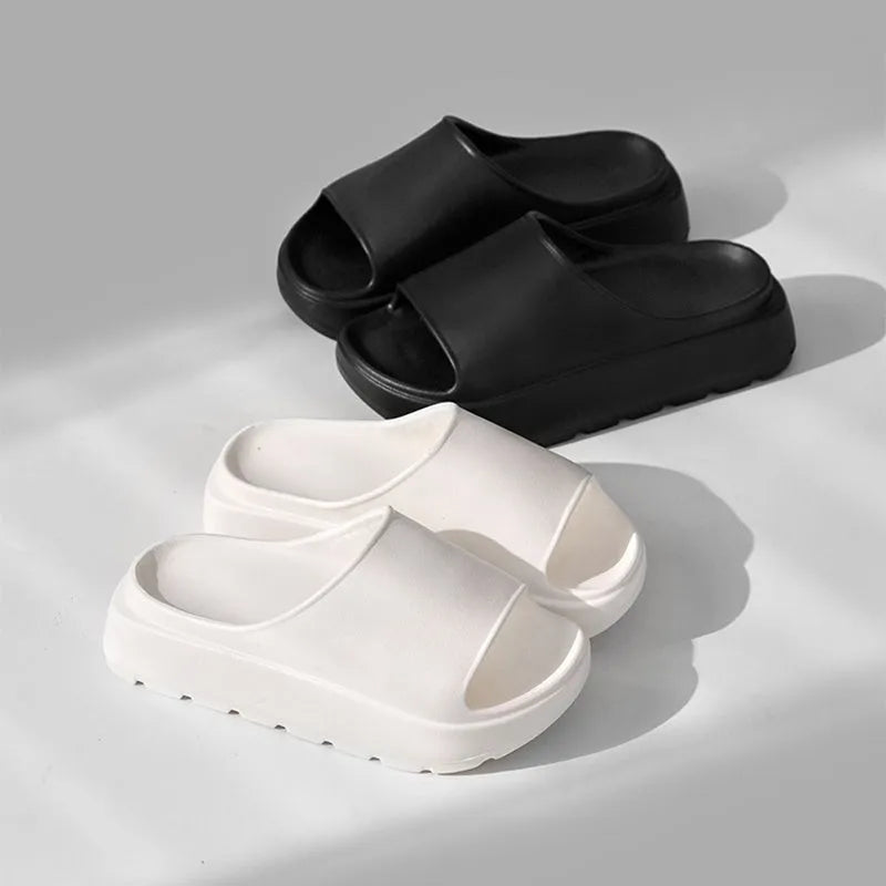 Women's beige fish mouth slippers with a thick sole on a wooden floor.