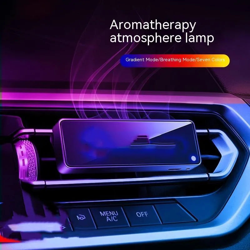 Black automobile air vent clip with LED light and aromatherapy diffuser for car odour removal.