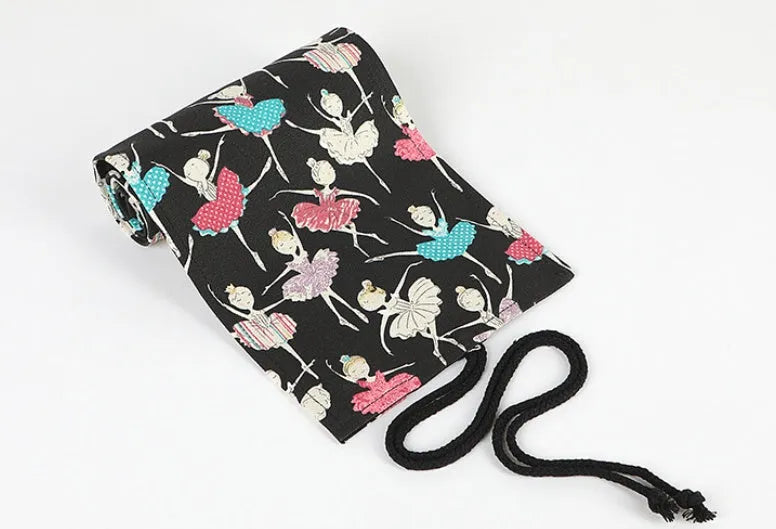 Square canvas rolling pencil case with ballet girl print, showing multiple pencil holes inside.