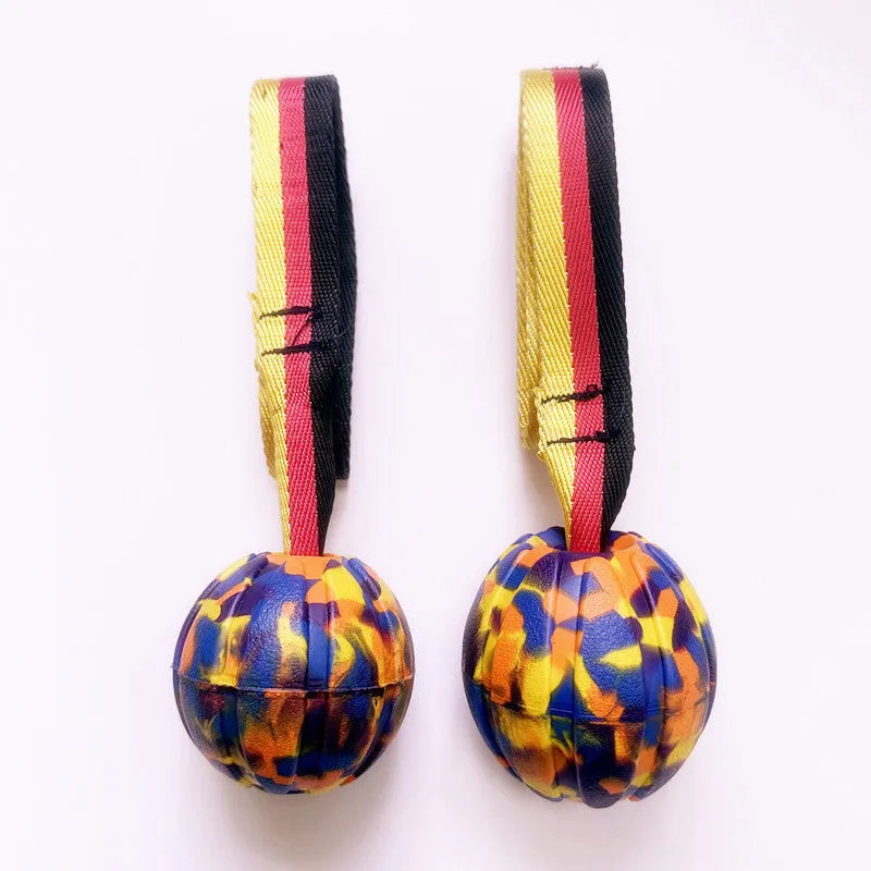 Yellow and camouflage coloured EVA foam floating tetherball dog toys in three different sizes on a blue background.