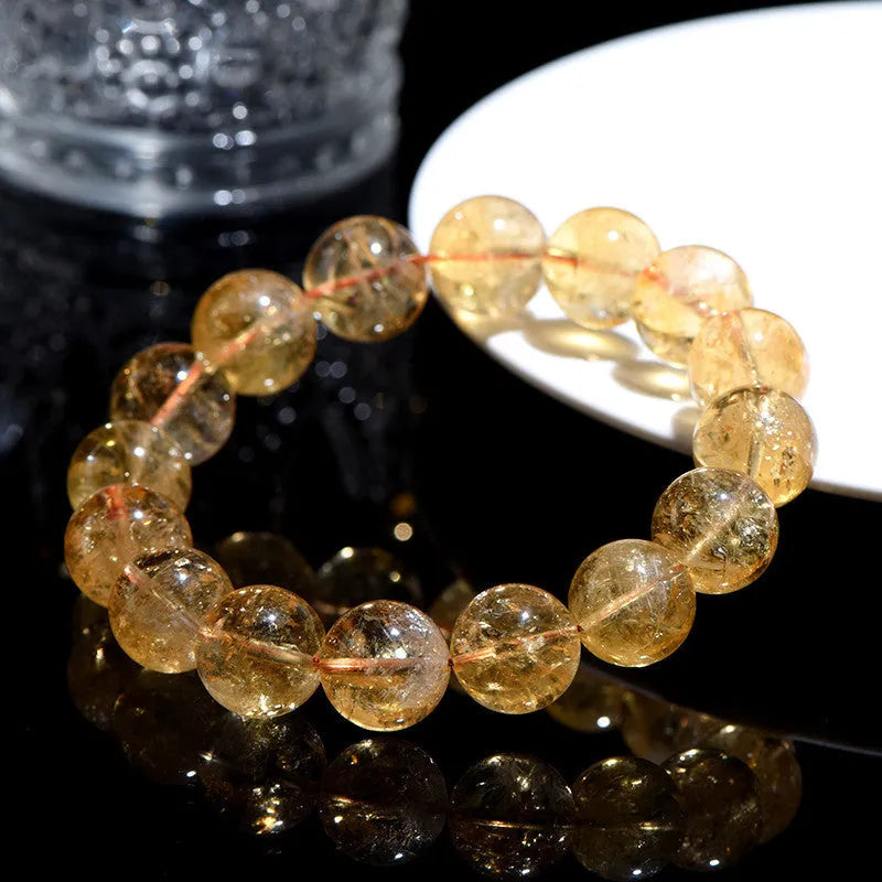 Natural yellow citrine bracelet with geometry-shaped beads in various sizes on display