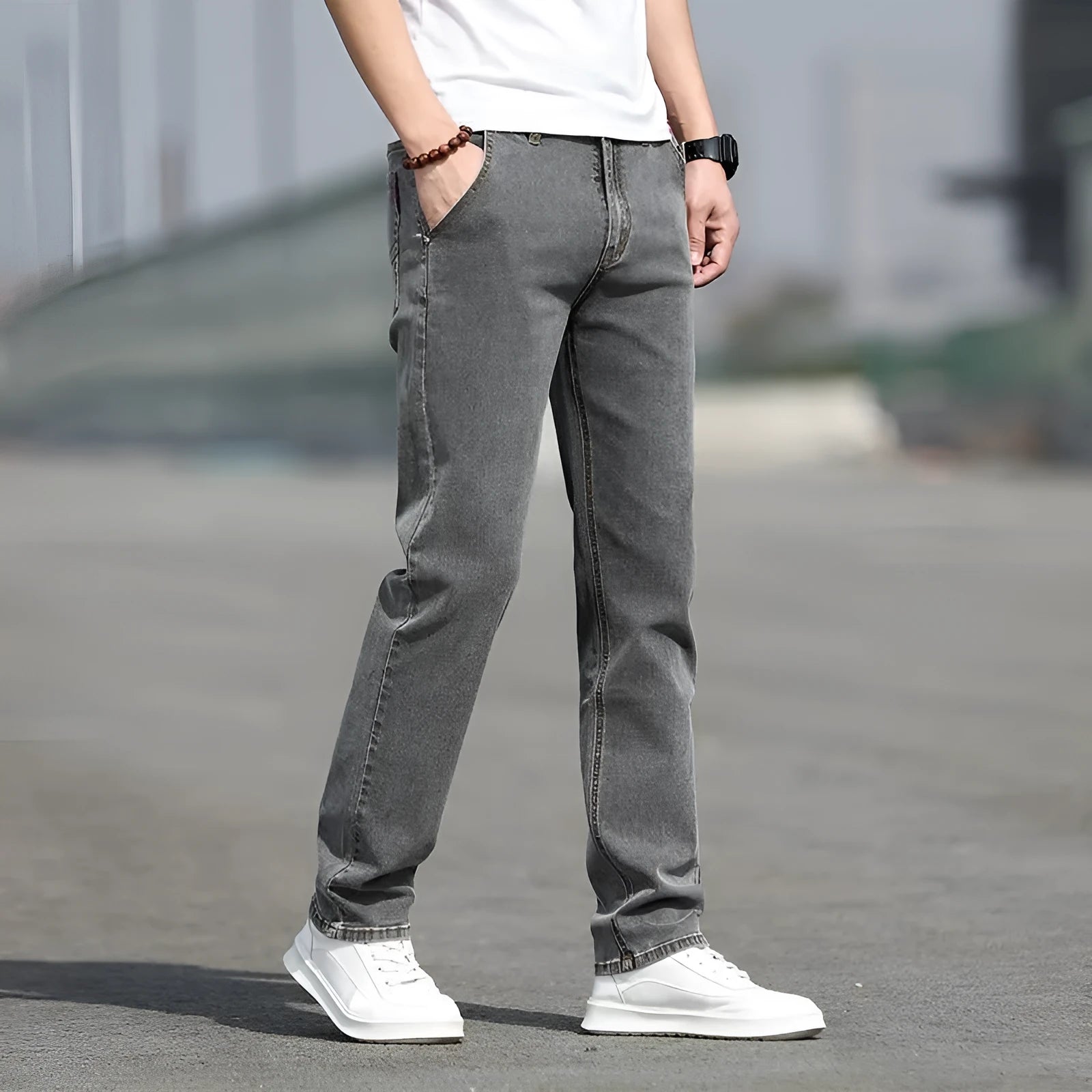 Man wearing smoky grey straight leg jeans with low waist and zipper fly.