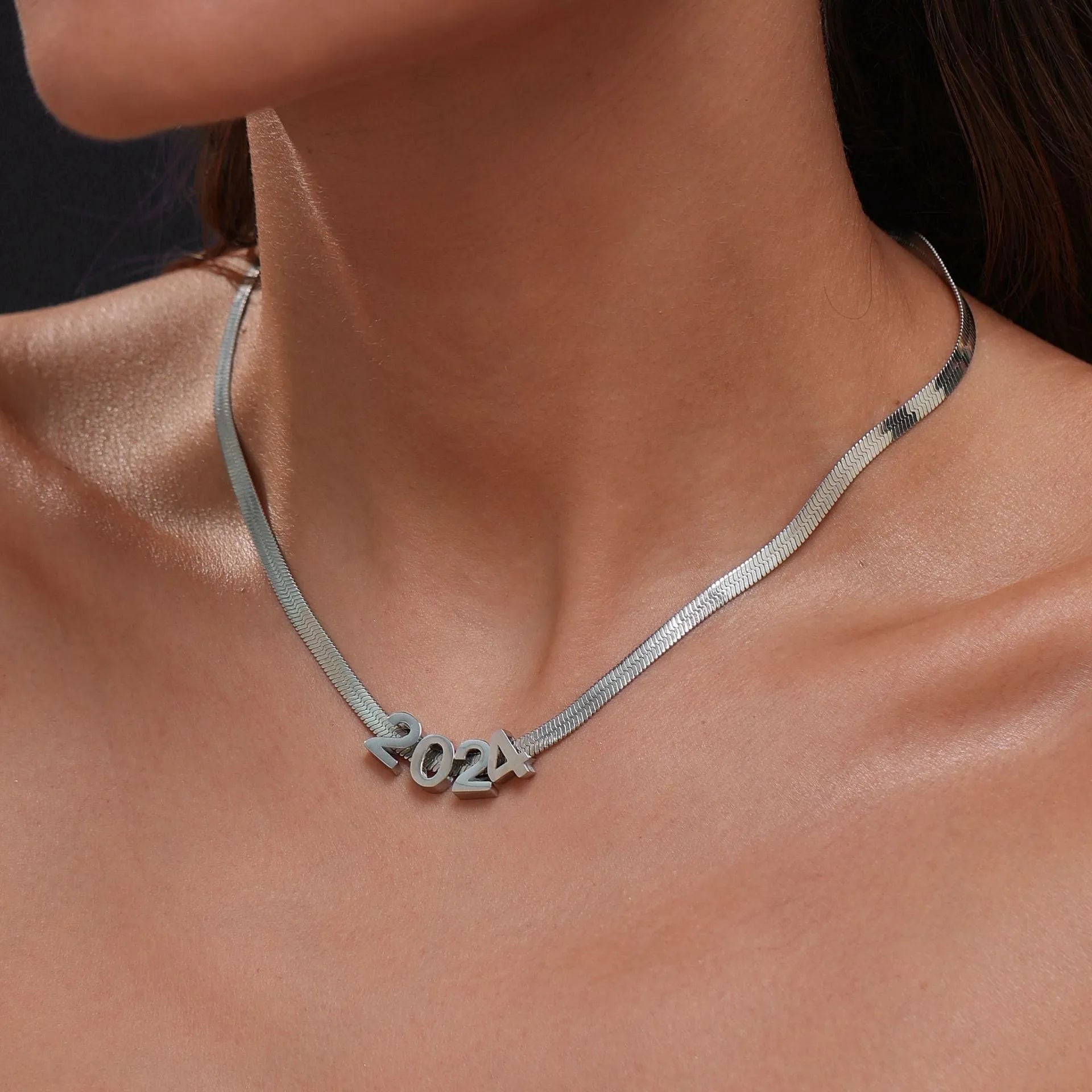 Titanium steel necklace with a choice of letter, number, or love heart pendant on a 40.5 cm chain.