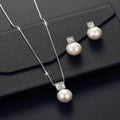 Versatile jewellery set with necklace and earrings featuring rhinestone cube pendants in rose gold finish