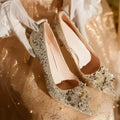 Champagne coloured pointed toe wedding heels with rhinestone floral detail on a fine heel.
