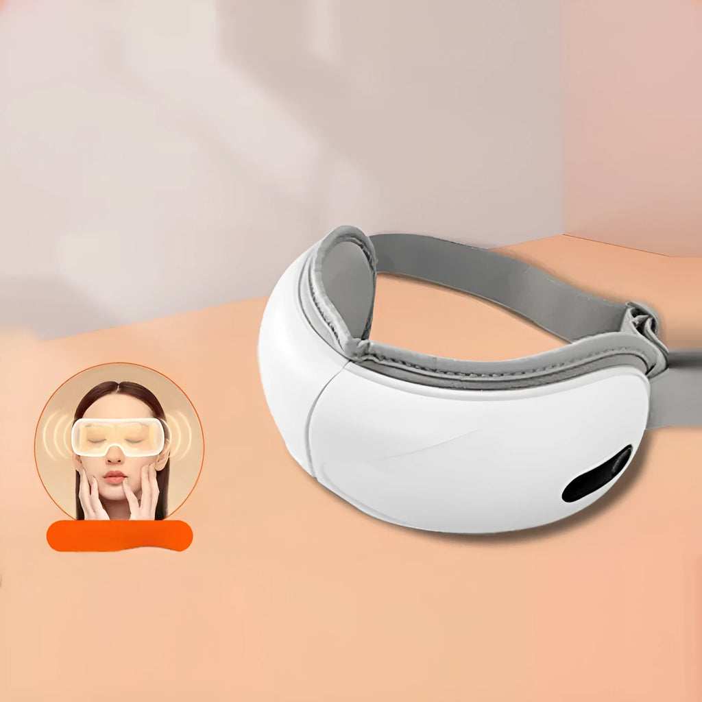 White rechargeable eye massager with airbag massage and hot compress function on a table.