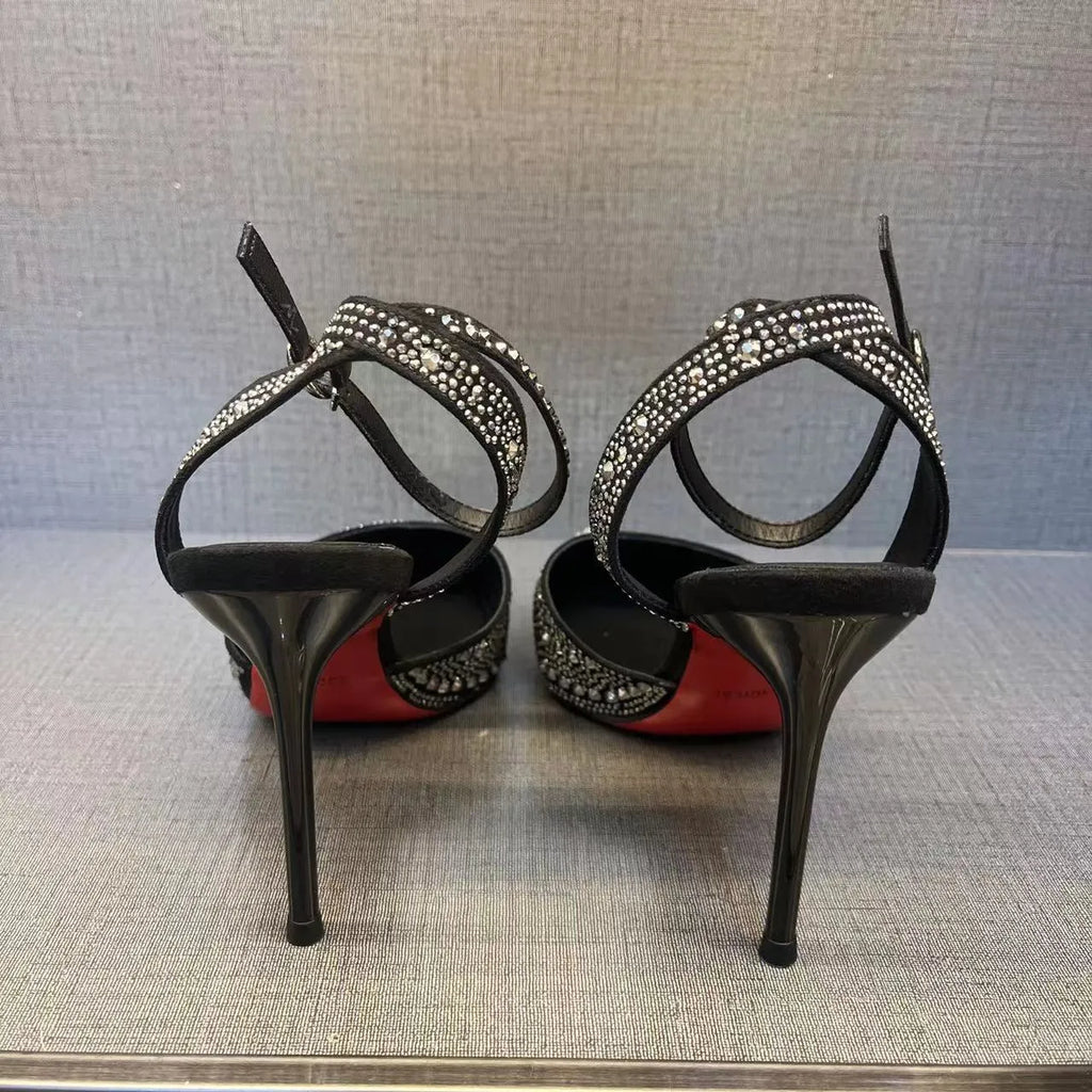 Women's black pointed toe high heels with a hollow stiletto heel and red sole, shown from the side.