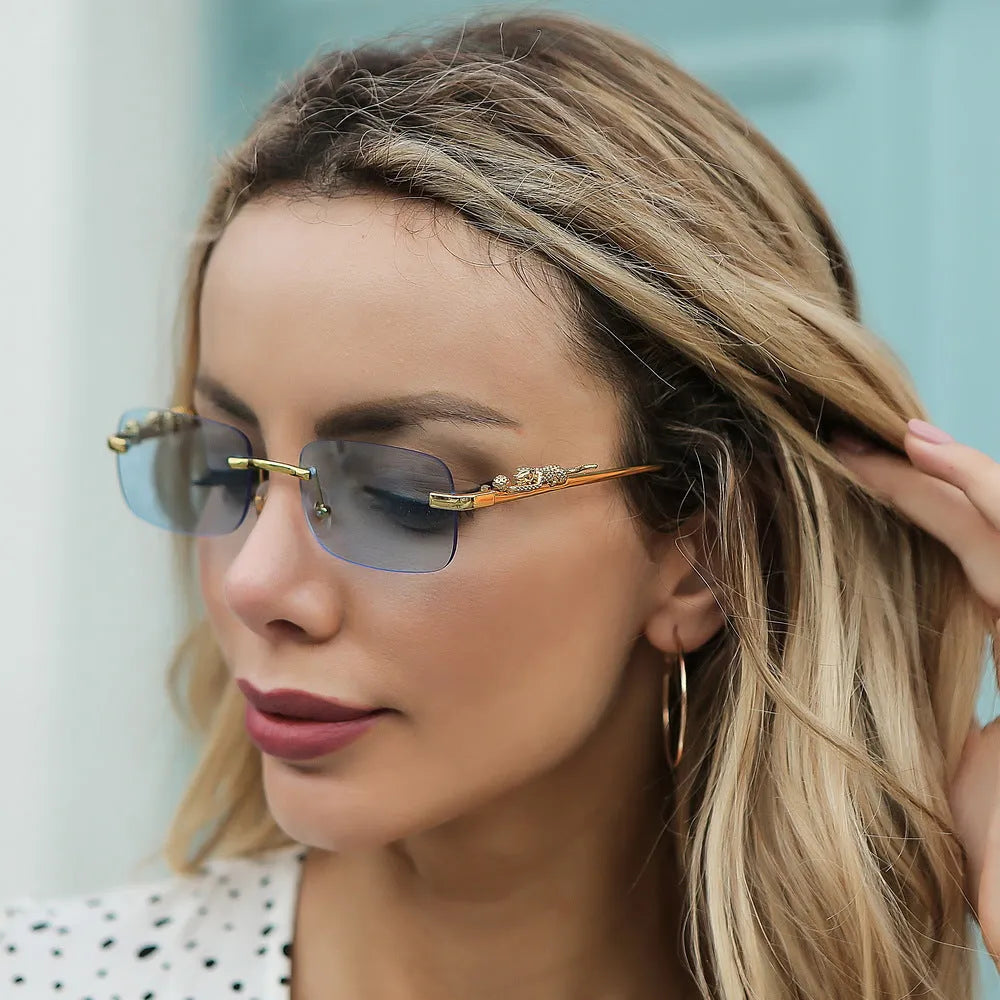 Gold metal leopard head frameless square sunglasses with pink PC lenses on a white background