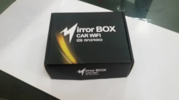 Black car mirror link box Wi-Fi A/V converter with power cable, antenna, AV cable, and manual for smartphone screen mirroring.