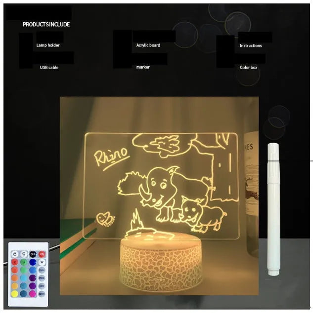 3D acrylic LED message board night light with remote control and marker pen on a desk.
