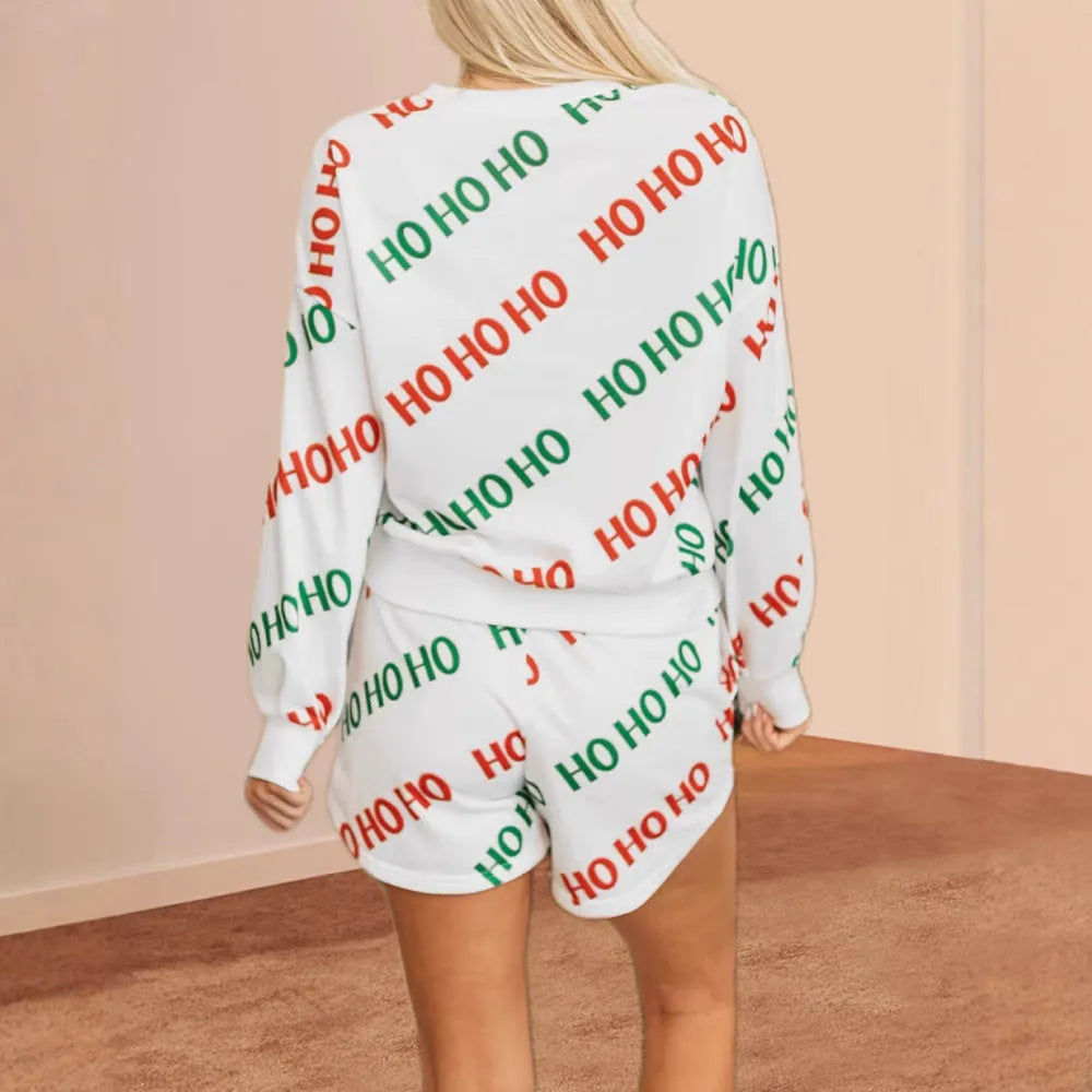 White women's two-piece suit with printed letters design, long sleeves, and matching trousers