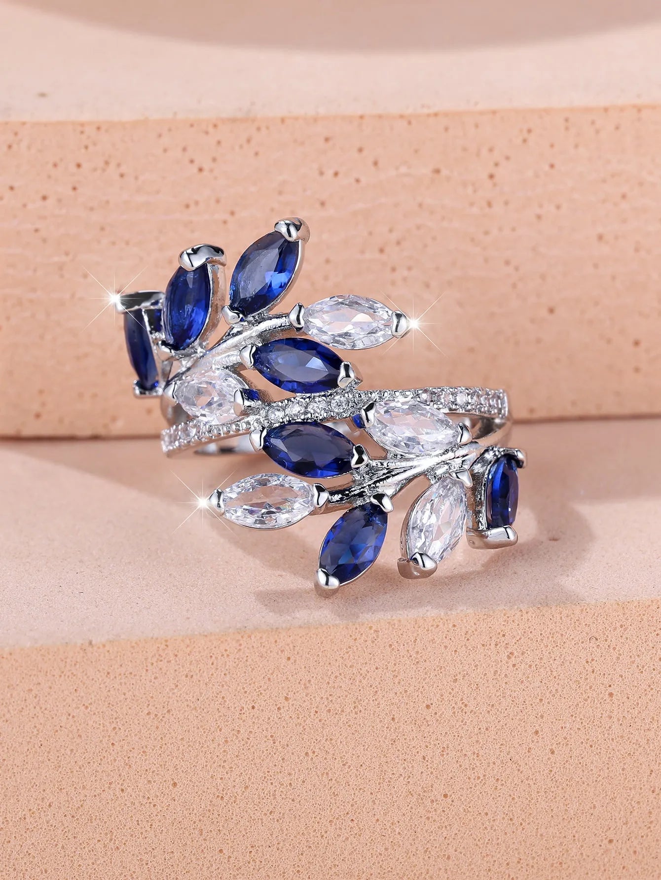 Adjustable horse eye design leaf ring in copper with zircon crystals, shown in a rose gold finish